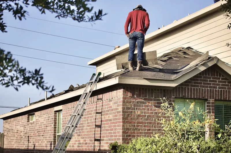Professional roofer working on a residential roof in Shore Road Estates